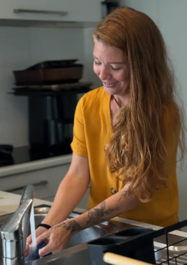 Owner of Back Up Crew, Sarah, cleaning in a kitchen